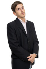 Young handsome tall slim white man with brown hair looks haughty in black blazer isolated on white background