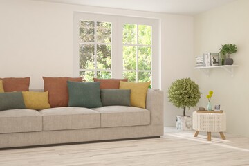 Fototapeta premium White living room with sofa and summer landscape in window. Scandinavian interior design. 3D illustration