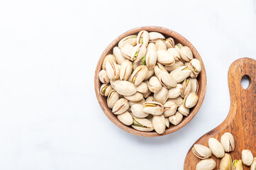 pistachios nuts in wooden bowl