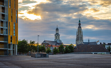 Fototapeta na wymiar Skyline of Breda with two churches by the sunset