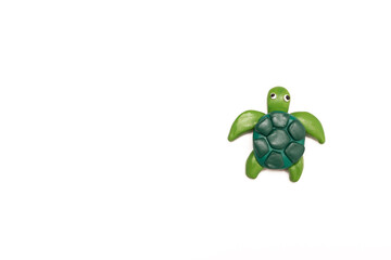 a small plasticine turtle on a white background