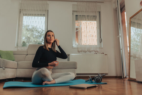 Woman getting ready to start training at home with a help of an online fitness instructor