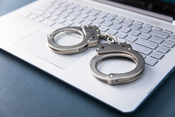 handcuffs on the white computer
