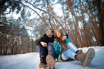 A loving couple on the background of a winter landscape.