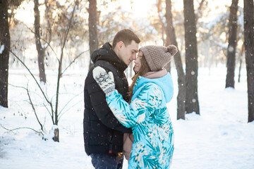 A loving couple on the background of a winter landscape.