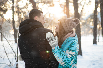A loving couple on the background of a winter landscape.