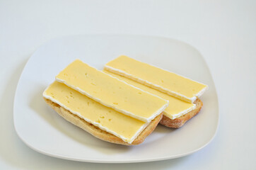 Two Sandwiches with Camembert cheese on white Plate