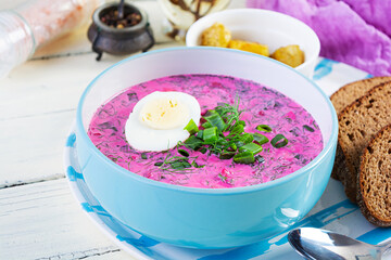 Cold borscht on white wooden background. Cold beet soup