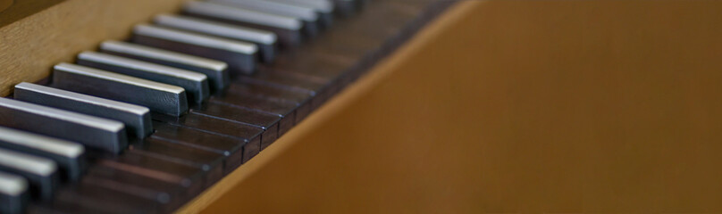 A Photograph of a Piano or Organ With Black Keys, Which has Copy Space