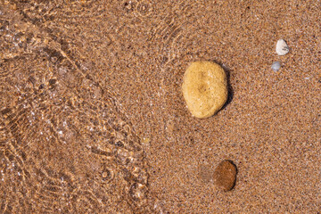 Fototapeta na wymiar Soft wave of the sea on the sandy beach.