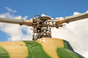 Fragment of a helicopter. Helicopter propeller against a cloudy sky. Helicopter propeller. Part of...