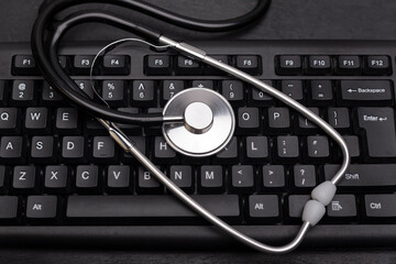 Stethoscope on the computer keyboard. Online consultation with a doctor.