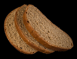 Three slices of dark bread on a black background isolated