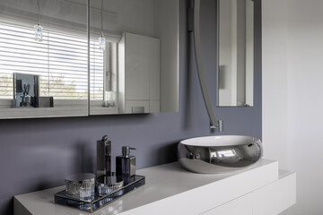 Glamor bathroom interior with trendy grey design with white furniture