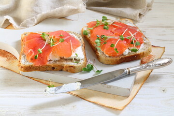 Bruschetta with salmon and cream cheese on a white plate