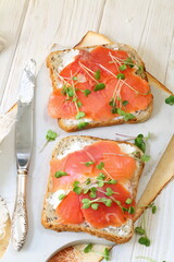 Bruschetta with salmon and cream cheese on a white plate