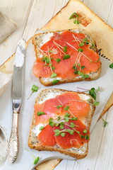 Bruschetta with salmon and cream cheese on a white plate