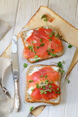 Bruschetta with salmon and cream cheese on a white plate