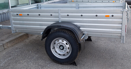 A store that sells trailers.Car open trailer. Transport for cargo transportation.