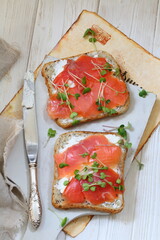 Bruschetta with salmon and cream cheese on a white plate