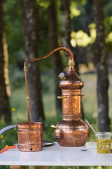 Antique copper still on an outdoor laboratory table