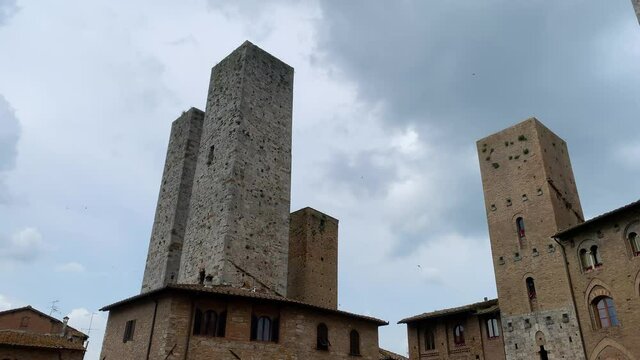 Old medieval architecture with towers in San Gimignano city, Italy - (4K)