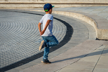 Fototapeta premium The boy is dancing in the street alone.