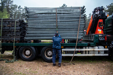 Extensive metal scaffolding providing platforms for workers, used in construction areas.