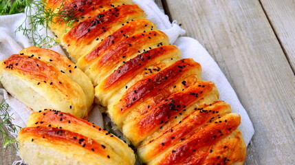 yeast pie stuffed with potatoes cooked at home in the oven close-up selective focus, homemade bread.