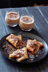 Chocolate pancakes and coffee for breakfast in the sunny morning