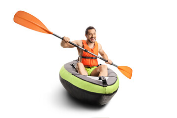 Smiling young man in a canoe with a life vest and a paddle