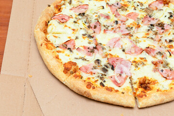 Close up Above top view of baked hot tasty and fresh homemade Pizza Carbonara in the delivery box with Bacon, cheese, onion, mozzarella