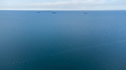 Fototapeta premium Cargo ships at the roadstead of the commercial port. Calm. Aerial view.