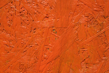 chipboard painted in orange color textured background