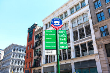 A bus stop sign by Metropolitan Transportation Authority in SoHo neighborhood. No Standing warning...