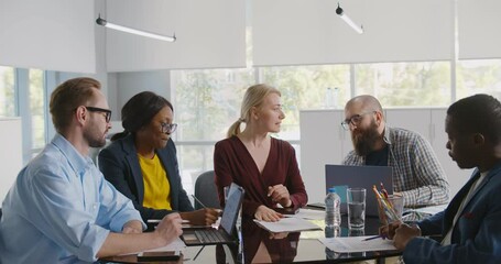 Young business people in smart wear using modern technologies and working together on new project - Powered by Adobe