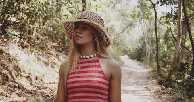 Amazed and Joyous Young Blonde Traveler Strolling on a Cambodian Forest 