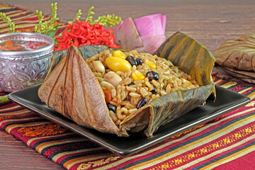 Rice wrapped in Lotus leaf. Famous Chinese cuisine. Vegetarian food. Sticky rice cooking with soy...