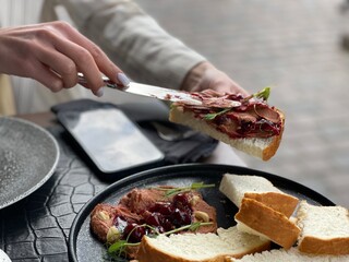 spreads pate on bread