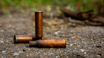 Three old brown bullet casings close up