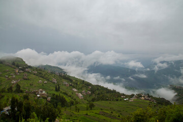 A small village at the top of Ibb mountains in Yemen. with a cloud