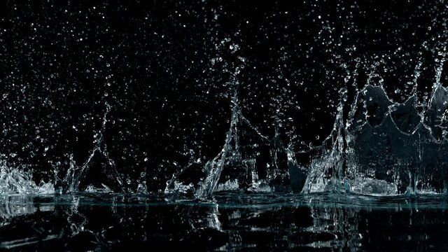 Super slow motion of splashing water isolated on black background. Filmed on high speed cinema camera, 1000 fps.