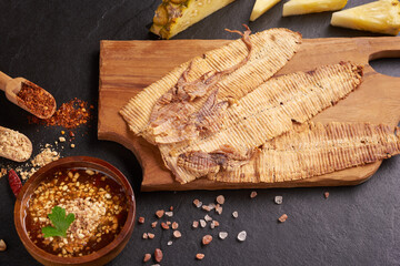 Grilled dried squid with sweet and sour sauce, Grilled dried squid with herbs and spices, various vegetables on wooden, Mashed squid is materials raw from the sea, street food