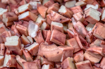 Pieces of sea cuttlefish squid cut into cubes. Ready-made ingredients for sea salad