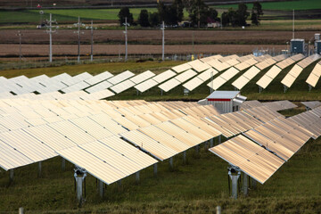 Tilting solar farm panels outside of Warwick at sunset