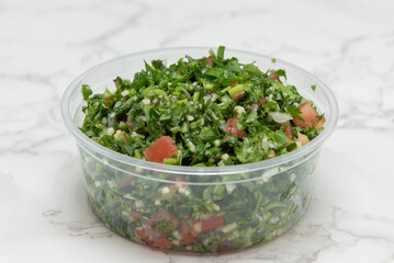 Tabouli salad presented in a clear bowl for a Mediterranean meal on the go