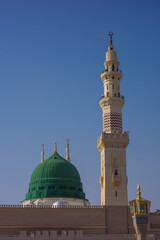 Fototapeta na wymiar View of green dome of Nabawi Mosque in the morning during afternoon in Al Madinah, Saudi Arabia.