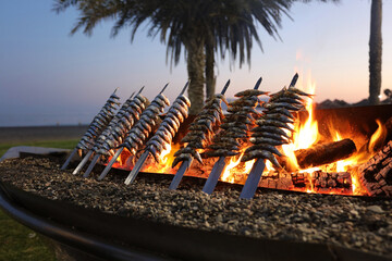 Sardine thickness with fire at sunset, typical Malaga city mediterranean food