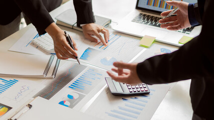 business women and men reading financial reports Businesswomen and men reading financial reports, discussing, analyzing, calculating graph documents that Asian female and male managers discuss and scr