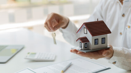 Real estate business, sales representatives offer home purchase contracts to buy a house or...